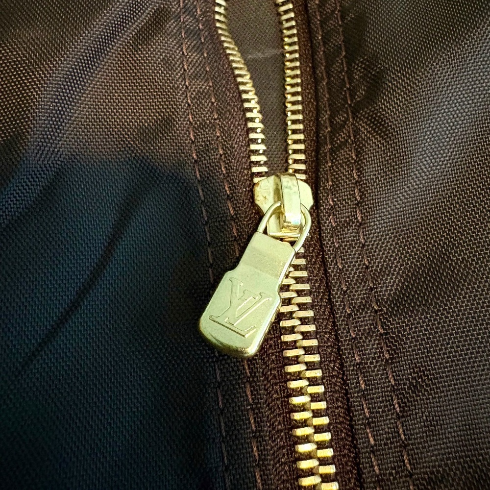 Louis Vuitton.  A Brown Nylon Suiter Garment Bag with Gold Hanger